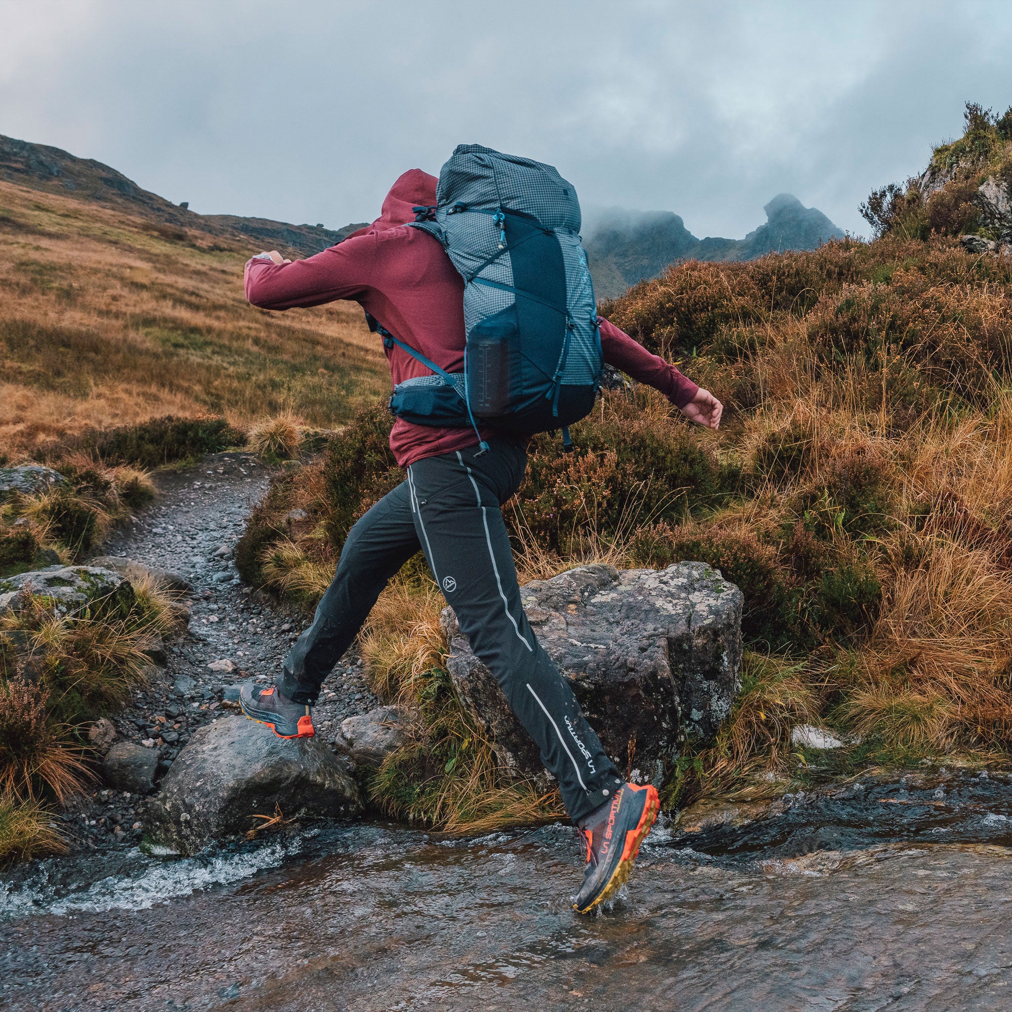 EXPED Lightning navy crossing a stream in scotland